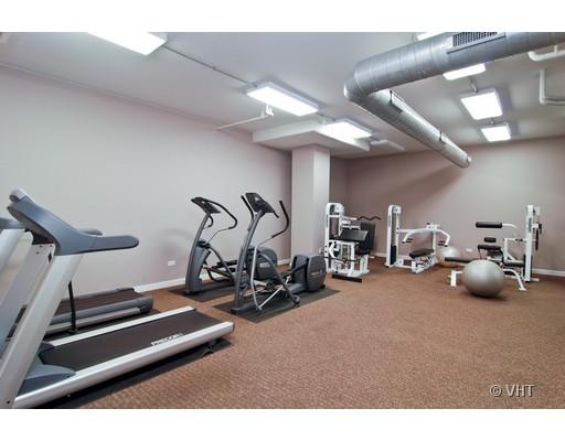 Indoor gym area with various exercise equipment including treadmills and weight machines.
