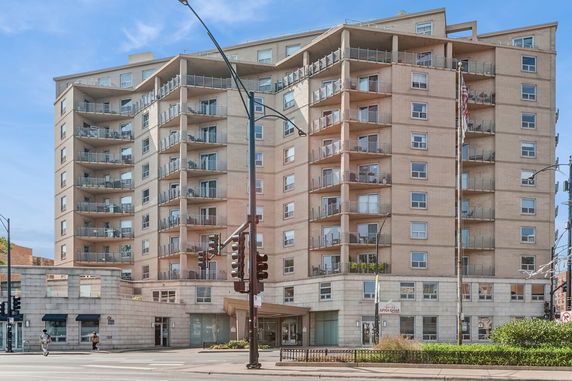 Front view of a multi-story residential building with balconies.
