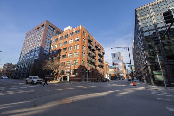 Street view of multi-story brick and glass building