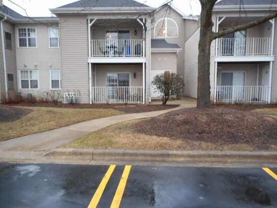 Front view of a two-story residential building with balconies.