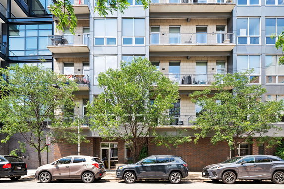 Front view of a multi-story residential building with balconies.