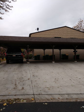 Open parking area with a covered parking shade.