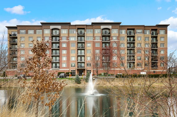 Front view of a multi-story apartment building with balconies.