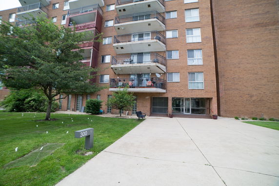 Front view of a multi-story apartment building with balconies.
