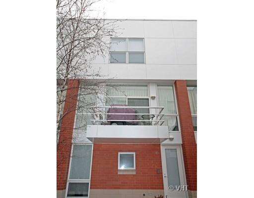 Front view of a multi-story residential building with a small balcony.