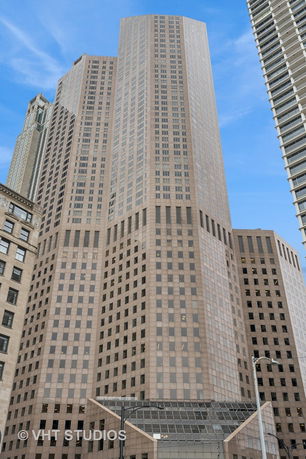 Front view of a tall office building with a grid-like window pattern.