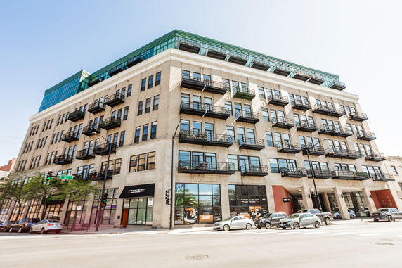 Front view of a multi-story residential building with balconies.