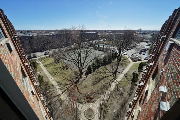 Panoramic view of surrounding areas with buildings and parking lots.