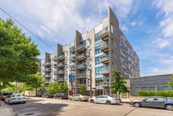 Front view of a multi-story apartment building with balconies.
