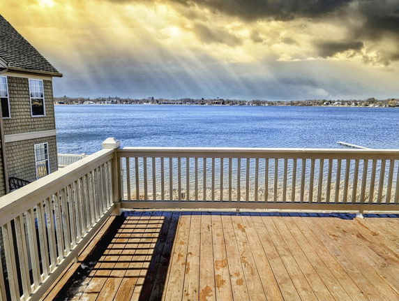 Panoramic view of a lake from the deck of a house.