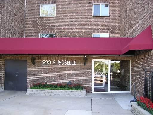 Front view of a multi-story brick building with an entrance canopy.