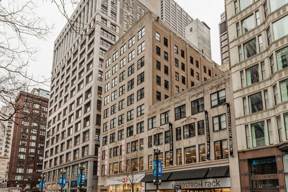 Front view of multi-story commercial buildings in a city setting.