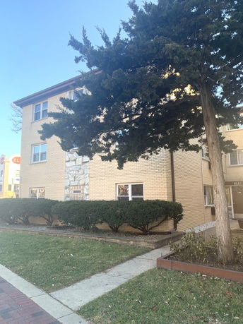 Front view of a multi-story residential building with brick exterior.