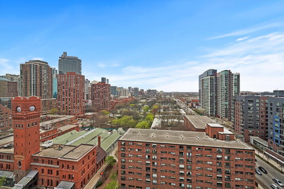 Panoramic view of a cityscape with multiple high-rise buildings and a distant horizon.