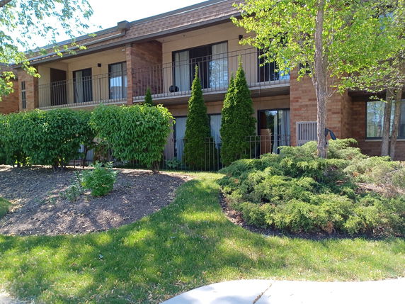 Front view of a two-story building with balconies.