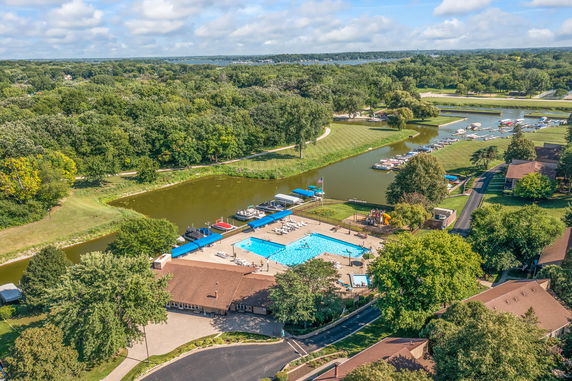 Panoramic view of a recreational area with a swimming pool and surrounding greenery.
