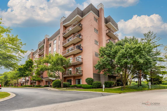 Front view of a multi-story apartment building with balconies.