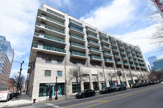 Front view of a multi-story residential building with balconies.