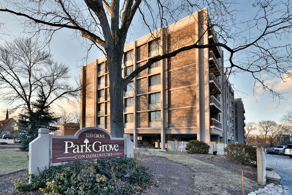 Front view of a multi-story condominium building with a brick facade.