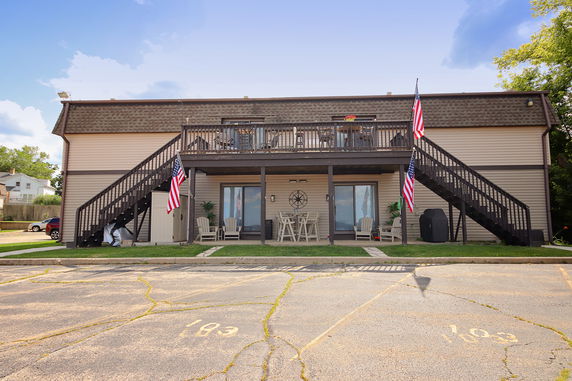 Front view of a two-story building with exterior stairs and balconies.