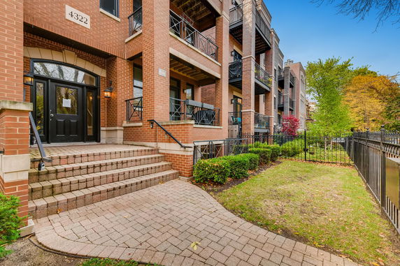 Front view of a multi-level brick building with balconies.