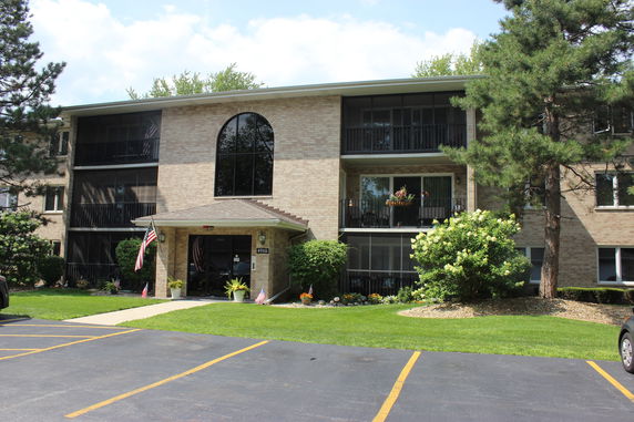 Front view of a three-story apartment building with balconies.