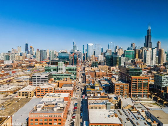 Panoramic view of a city skyline with various skyscrapers and buildings.