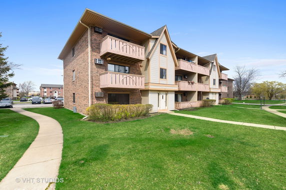 Front view of a two-story apartment building with balconies.