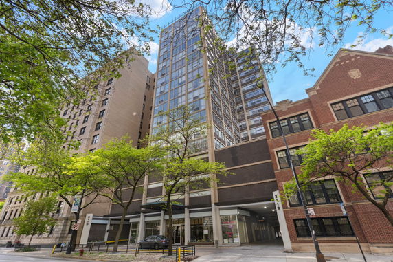Front view of a tall multi-story building in an urban setting