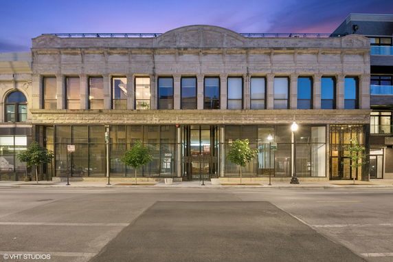 Front view of a two-story commercial building with large windows and a decorative facade.