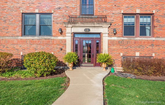 Front view of a brick building with decorative entrance and windows.