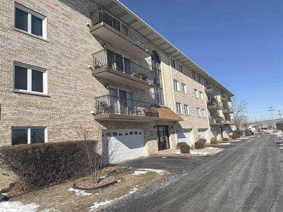 Front view of a multi-story residential building with balconies.