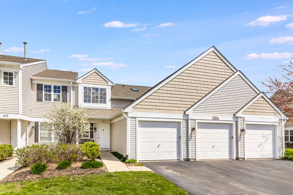 Front view of a residential building with attached garages.