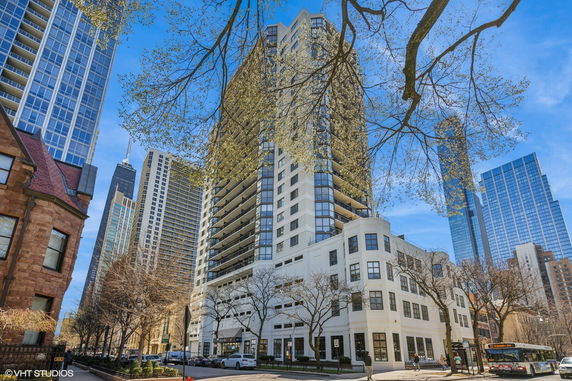 Front view of a tall apartment building in an urban area.