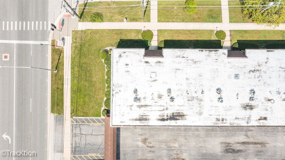 Aerial view of a flat rooftop with multiple air conditioning units.