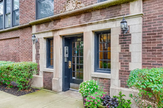 Front view of an apartment building entrance with decorative elements.