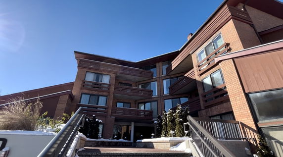 Front view of a multi-story brick building with balconies.