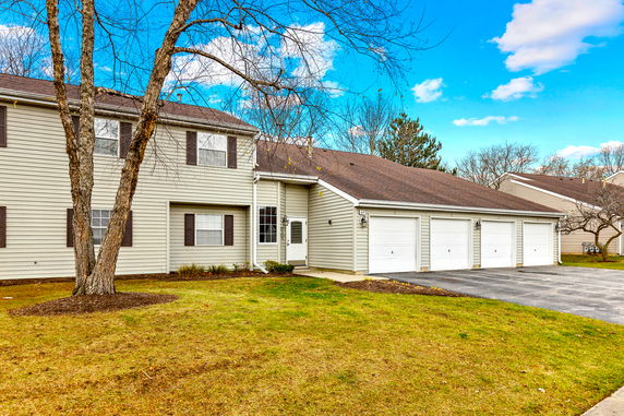 Front view of a two-story house with a triple garage.