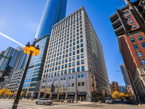 Front view of a high-rise office building with a modern glass facade.
