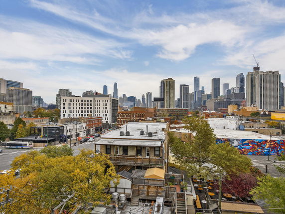 Wide-angle view of a cityscape with multiple buildings and skyscrapers.