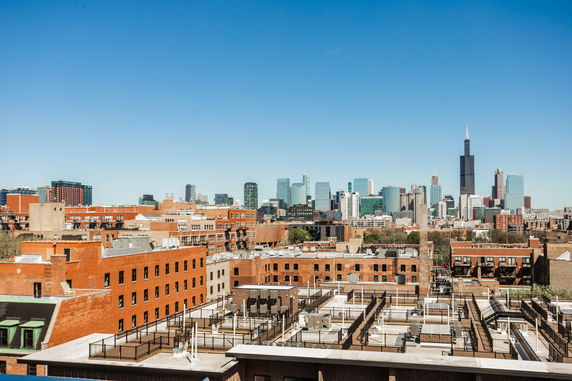 View of urban buildings with a city skyline in the background
