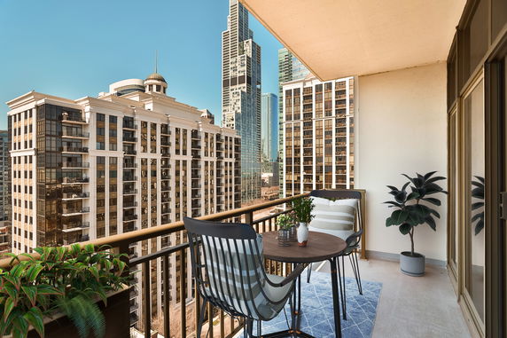 Balcony view overlooking tall urban buildings.