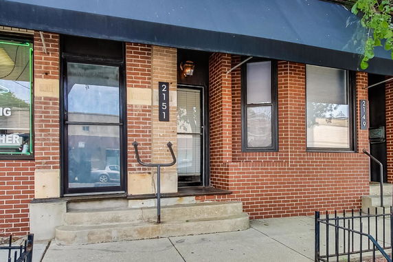 Front view of a brick building with multiple entrances.