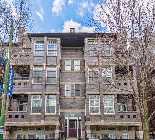 Front view of a multi-story brick apartment building.