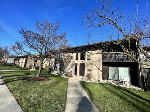Front view of a two-story residential building with a balcony.