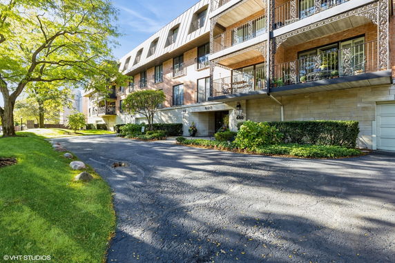 Front view of a multi-story residential building with balconies.
