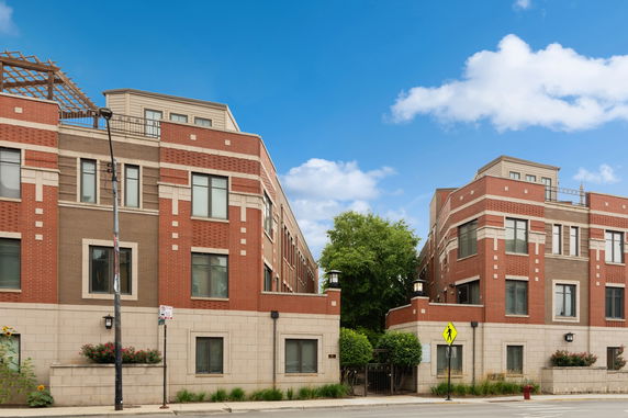 Front view of a multi-story building with brick and stone exterior.