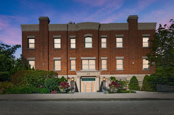 Front view of a multi-story brick building with symmetrical windows.