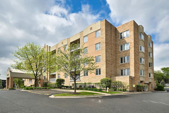 Front view of a multi-story brick apartment building.