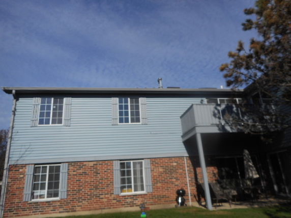 Front view of a two-story house with brick and siding exterior.